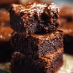 A plate of Grandma's brownies, rich and fudgy, perfect for dessert.