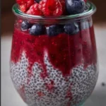High-protein berry chia pudding topped with fresh berries and nuts