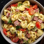 Bowl of Italian Grinder Tortellini Salad with fresh ingredients and vibrant colors