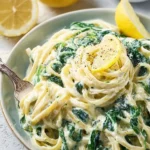 Lemon ricotta pasta with fresh spinach served in a bowl