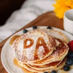 A plate of fun letter pancakes shaped in various letters, perfect for kids.