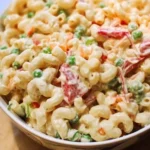 Delicious macaroni salad served in a bowl with vegetables