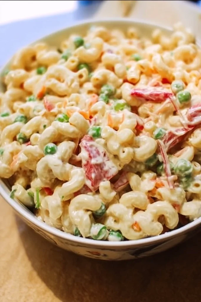 Delicious macaroni salad served in a bowl with vegetables