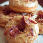 Delicious Maple Bacon Doughnuts topped with crispy bacon and maple glaze