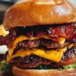 Delicious Maple-Whiskey BBQ Bacon Cheeseburger with crispy bacon and melted cheese