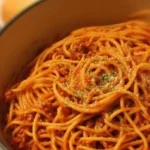 One Pot Spaghetti dish served in a bowl with herbs.