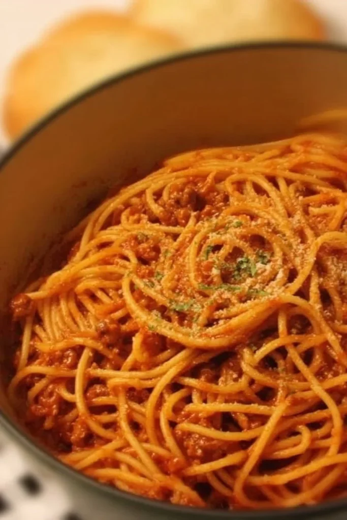 One Pot Spaghetti dish served in a bowl with herbs.