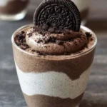 Decadent Oreo Mousse dessert in a glass with crushed Oreos on top