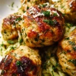 Delicious Parmesan-loaded baked chicken meatballs on a serving plate