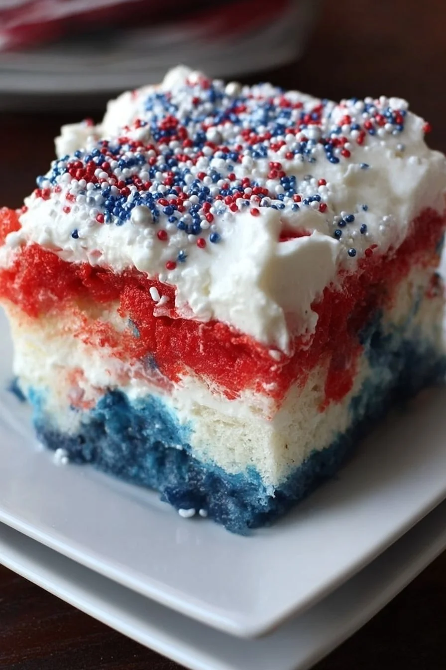 Patriotic Poke Cake decorated for the 4th of July, featuring red, white, and blue colors