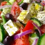 Colorful Greek salad with fresh ingredients and homemade dressing