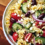 Colorful Greek pasta salad with vegetables and feta cheese