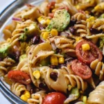Bowl of vibrant Vegetarian Taco Pasta Salad with fresh vegetables and pasta.